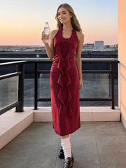 Burgundy halter midi dress with ruffle and rose detail.