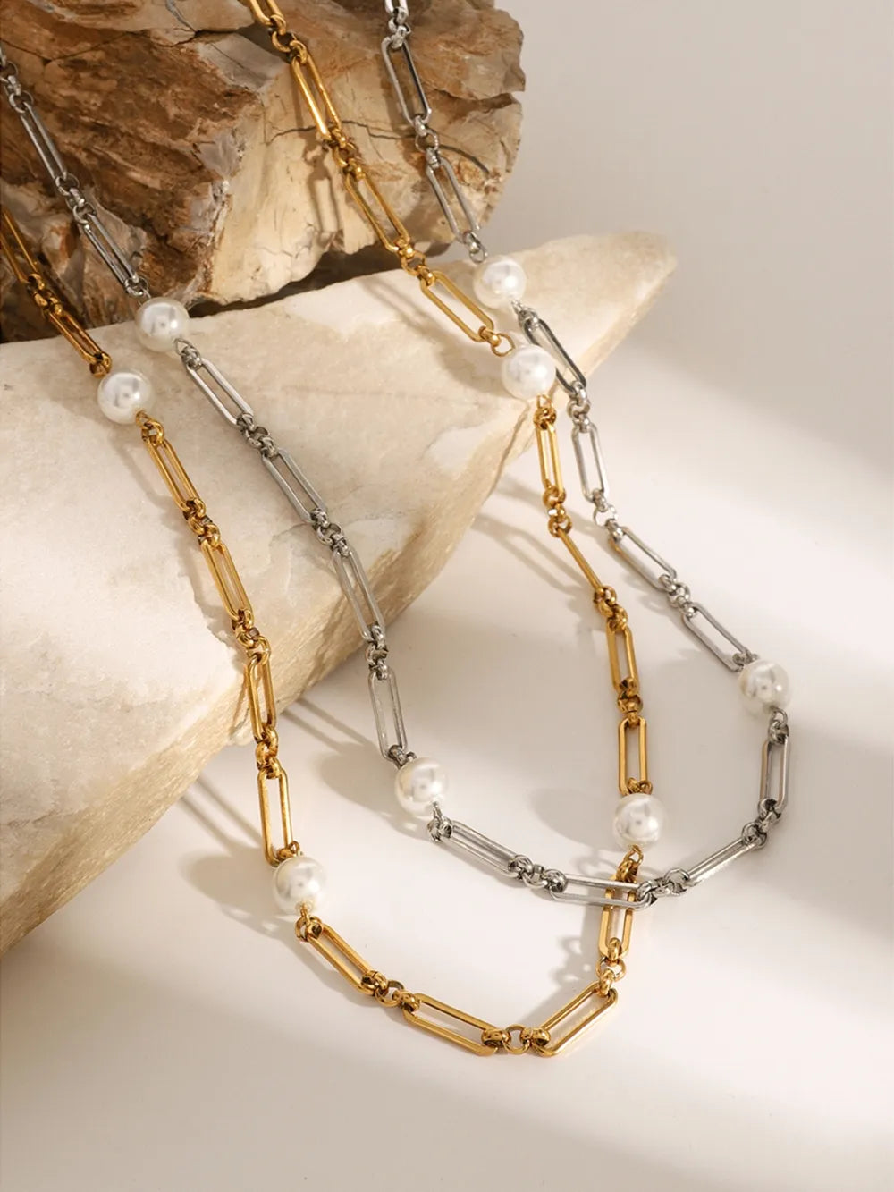 Two-tone pearl link necklace in gold and silver with paperclip chain details.