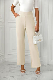 Beige wide-leg trousers with a sculpted waist and side pockets.