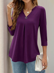 Violet V-neck three-quarter sleeve top with front pleats and a decorative button detail.