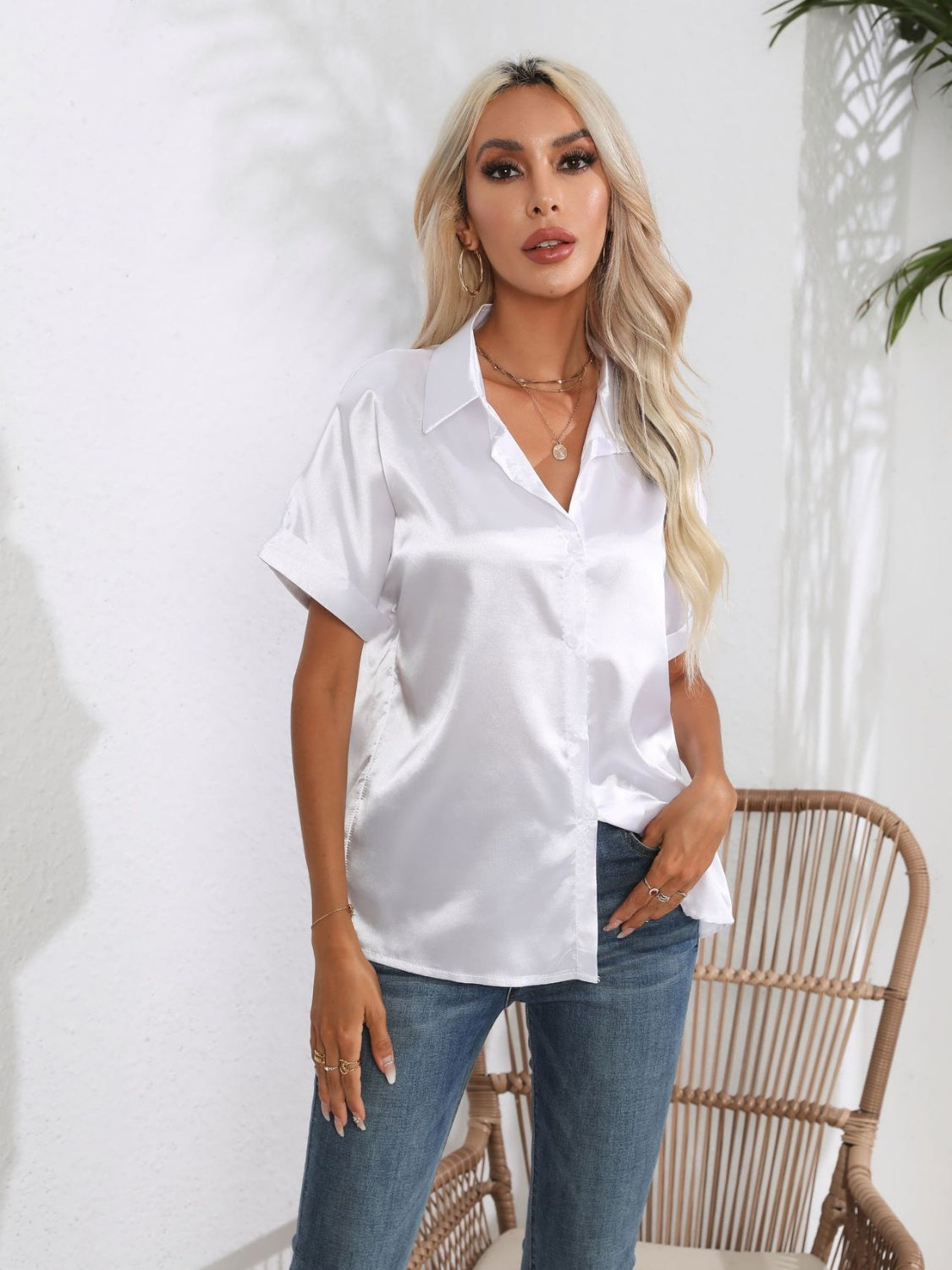 White satin boxy sleeve blouse with button-down front and collared neckline.