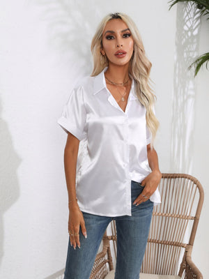 White satin boxy sleeve blouse with button-down front and collared neckline.