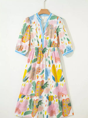 Midi dress with 3/4 sleeves, elastic waist, and tiered hem in a whimsical floral doodle print.