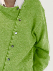 Matcha green knit cardigan with asymmetric button-up front and crew neck.