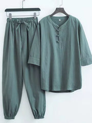 Relaxed fit Chinese-inspired men's pants set in sage green with drawstring waist and mandarin collar.