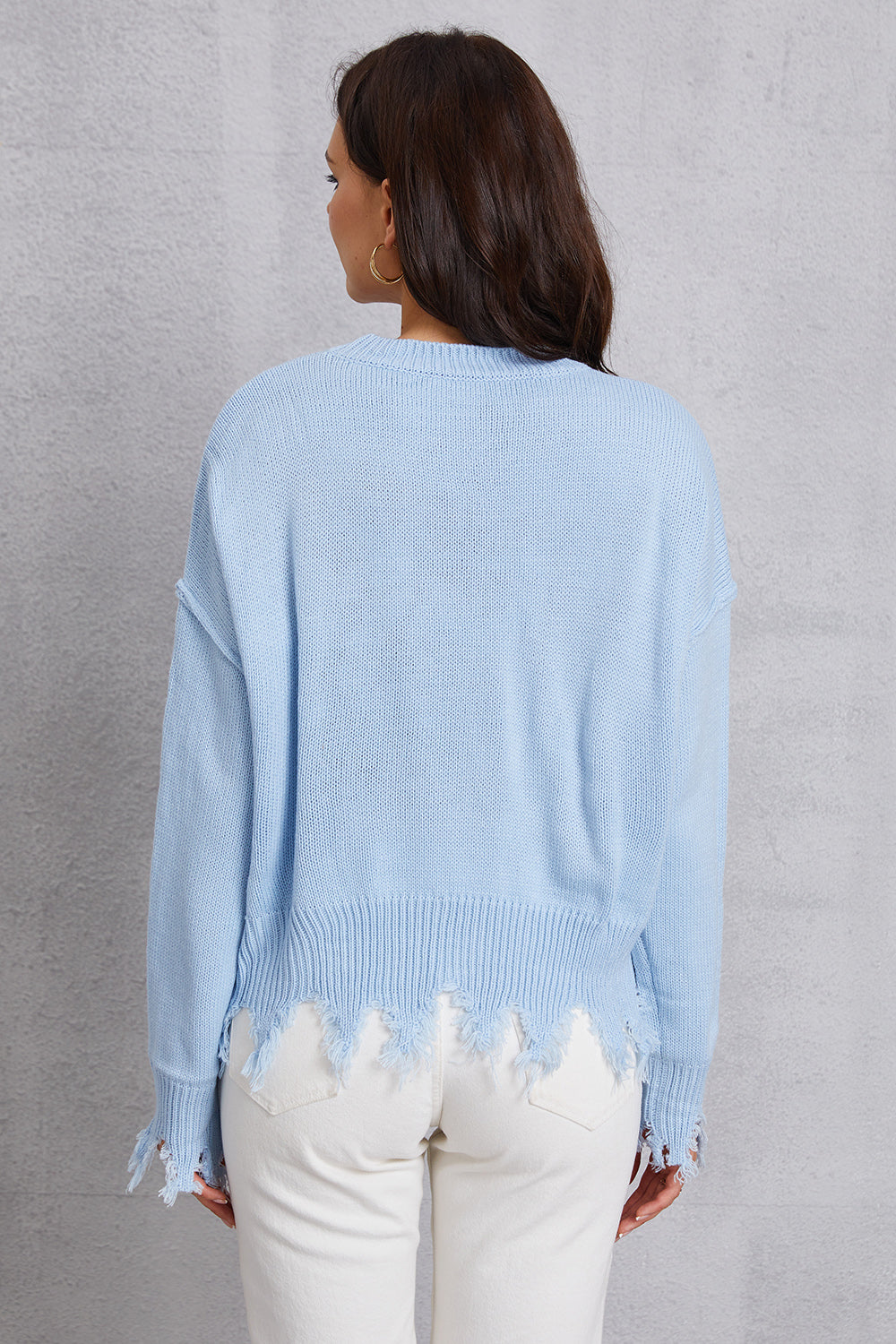 Light blue acrylic sweater with distressed hem and cuffs, crew neck, long sleeves.