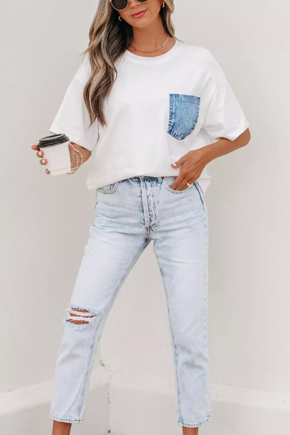 White cotton tee with a blue denim chest pocket, crew neck, and short sleeves.