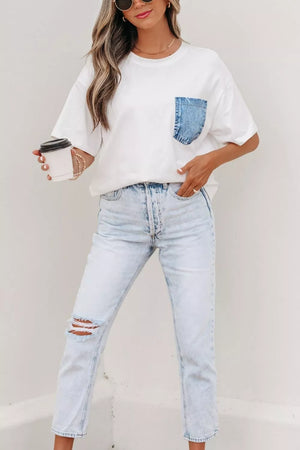 White cotton tee with a blue denim chest pocket, crew neck, and short sleeves.