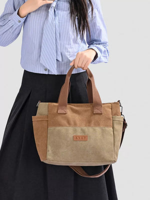 Multi-pocket canvas travel bag in taupe and tan with adjustable strap