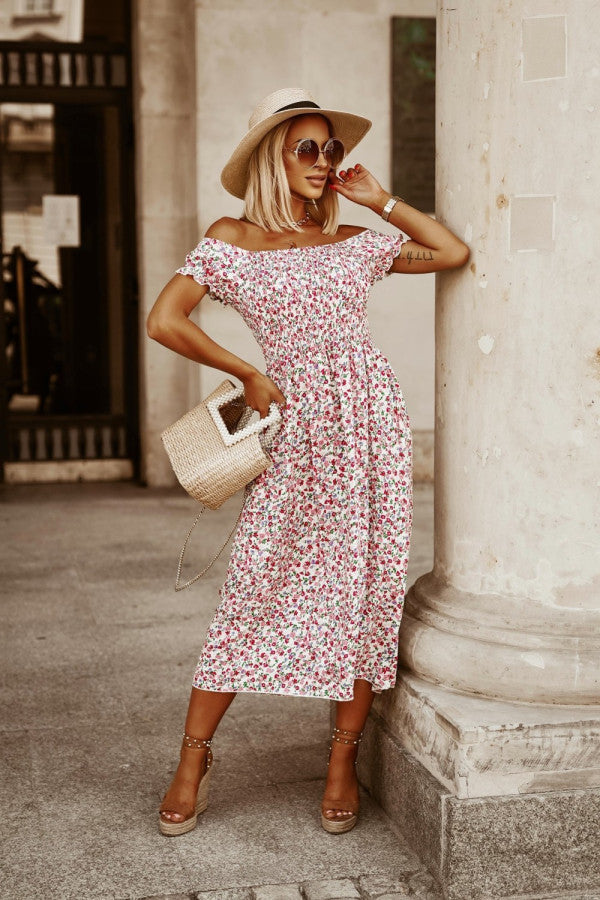 Off-shoulder midi dress with smocked bodice and floral print in white with pink flowers.