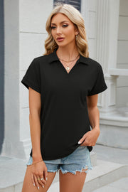 Black textured polo top with v-neck and cuffed short sleeves