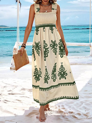 Cream maxi dress with green smocked bodice and floral print skirt.