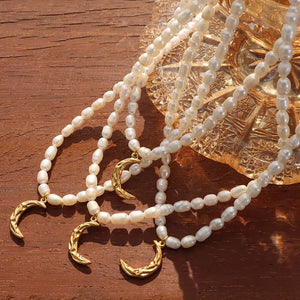 Gold pearl crescent moon necklaces with delicate chains and textured pendants.