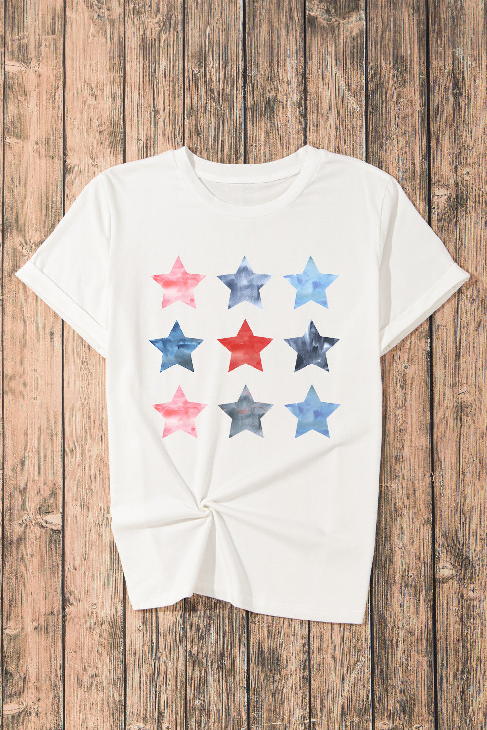 White crewneck tee with a watercolor starburst print in red, white, and blue.