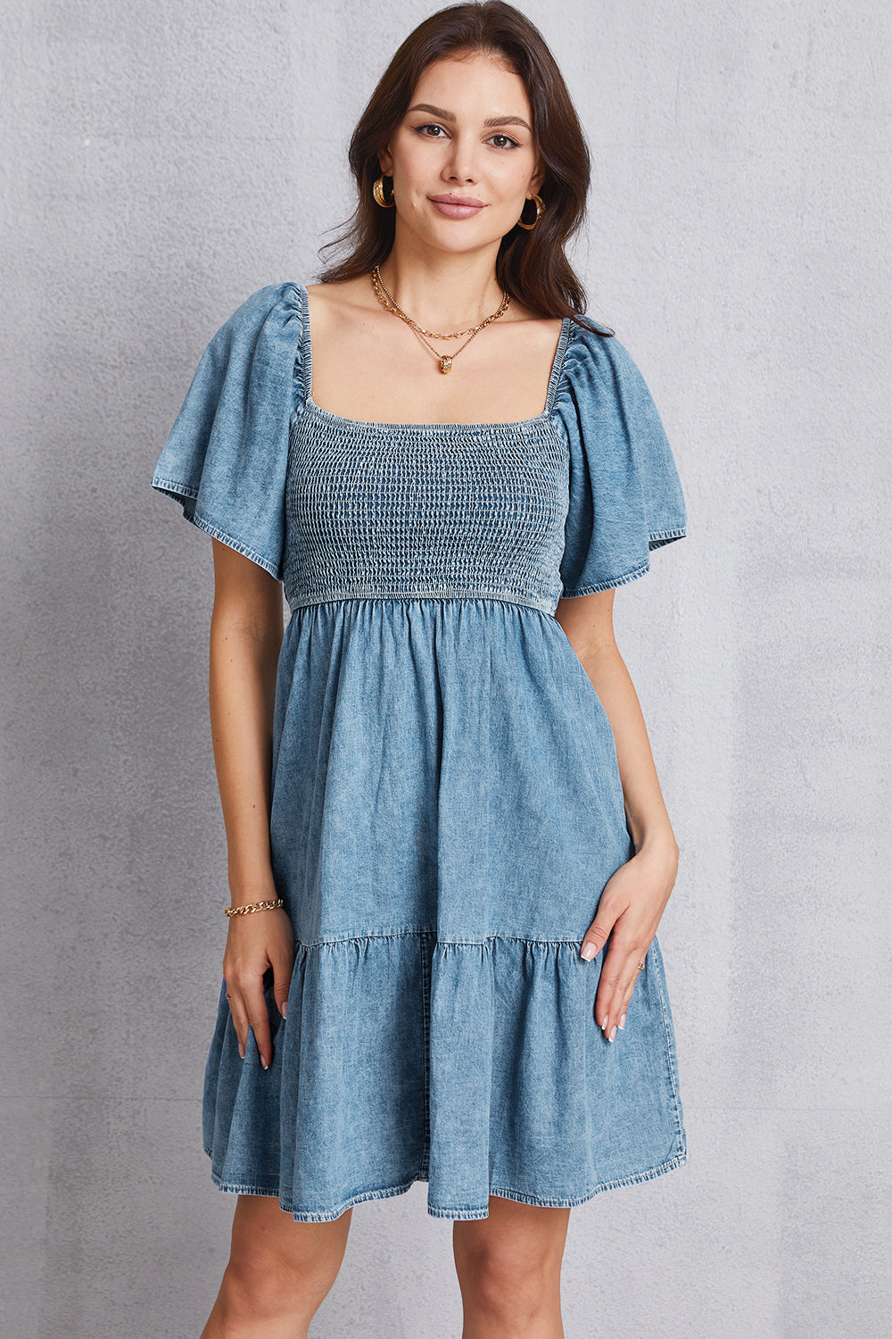 Light denim puff sleeve prairie dress with square neckline and tiered skirt.