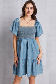Light denim puff sleeve prairie dress with square neckline and tiered skirt.