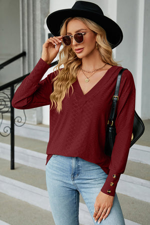 Burgundy diamond-textured V-neck blouse with button cuff detail