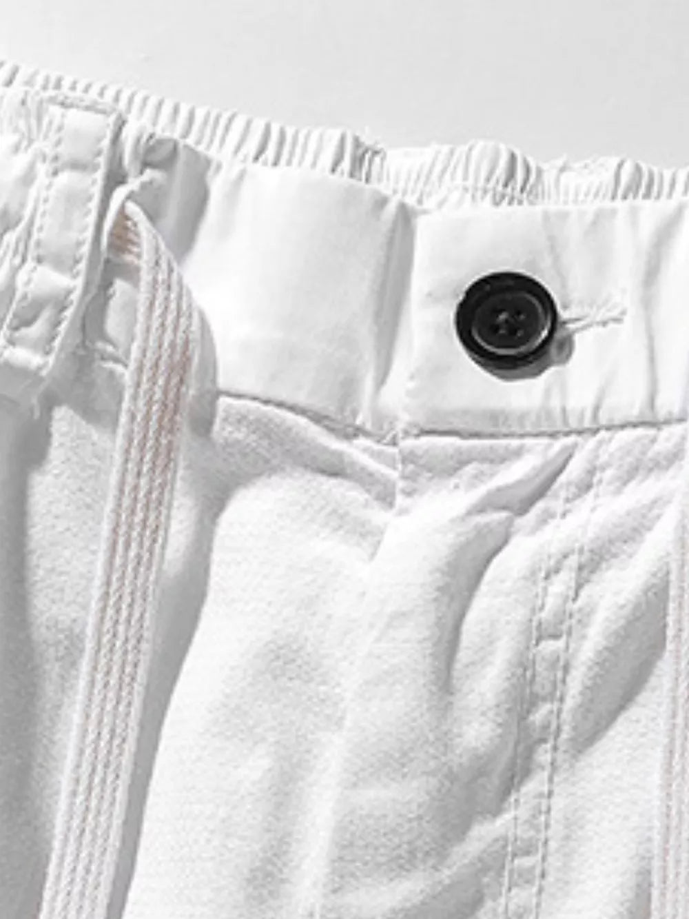 White men's cargo shorts with drawstring waist and button closure.