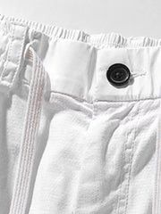 White men's cargo shorts with drawstring waist and button closure.
