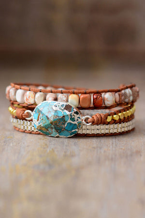 Turquoise and copper wrap bracelet set with natural stone beads and metal accents.