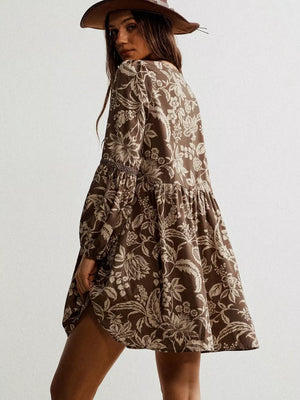 Brown floral print dress with balloon sleeves and tiered skirt.