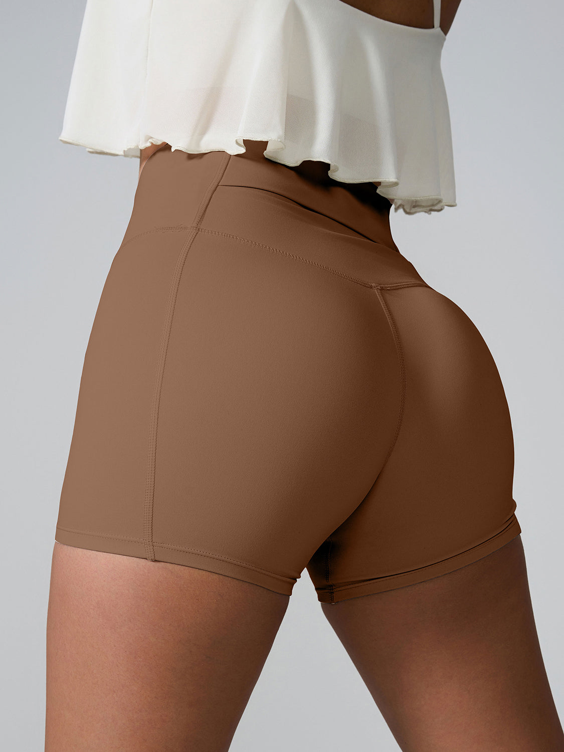 Sculpted active shorts in Chestnut brown with pocket detail and high waist.