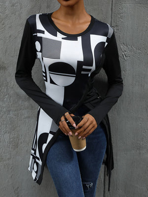 Black tunic with asymmetric geometric print, long sleeves, and a draped hem.