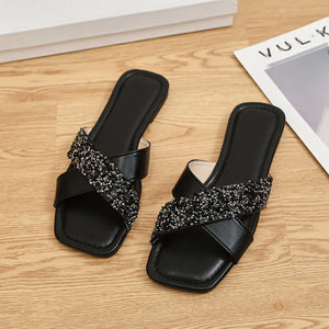Black sequined crisscross open-toe sandals with a square toe.