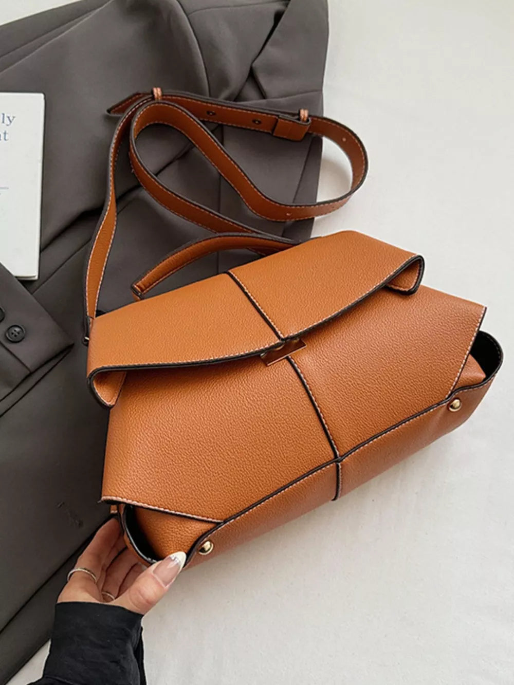 Brown textured geometric flap shoulder bag with adjustable strap