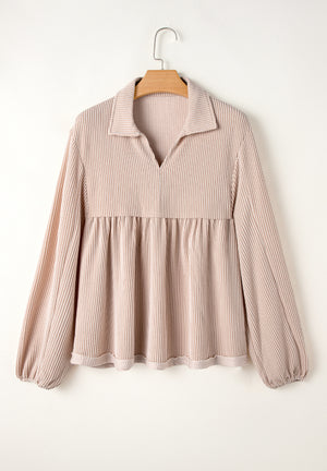 Beige textured blouse with gathered yoke, collar, and balloon sleeves.