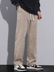 Tan cotton relaxed fit jeans with drawstring waist and front seam detail.