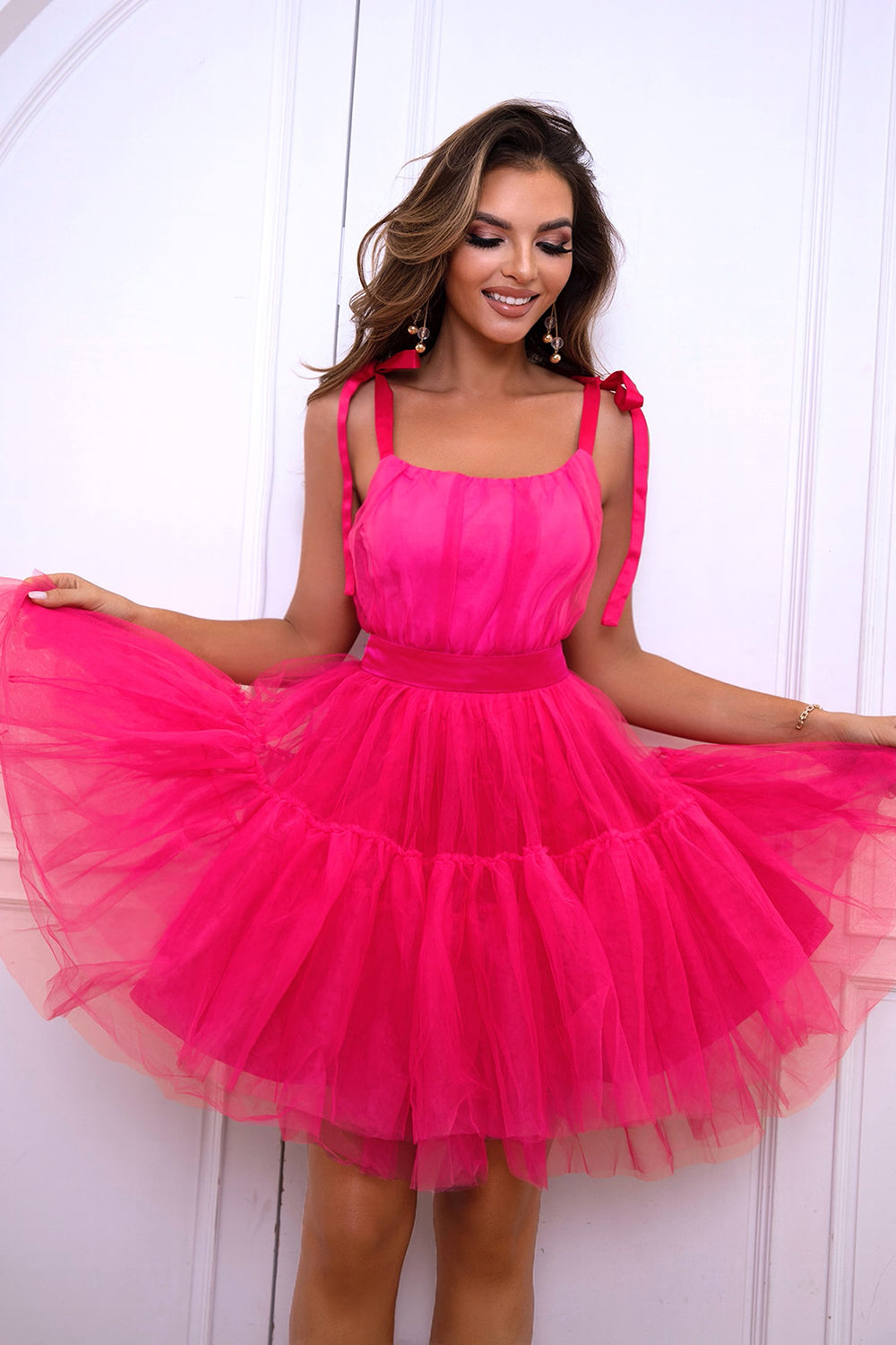 Hot Pink tulle tiered mini dress with bow straps and a square neckline.