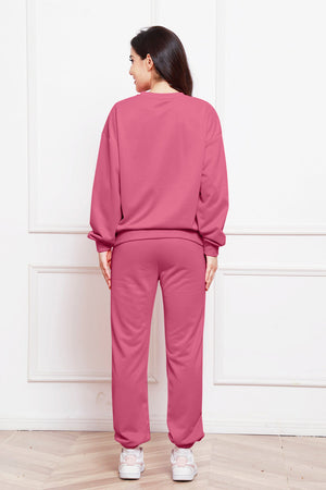 Relaxed fit loungewear set in hot pink, featuring a crewneck sweatshirt and matching sweatpants.