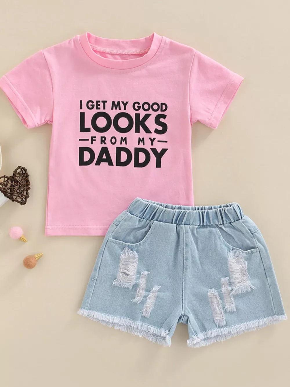 Pink cotton tee with black text and distressed denim shorts set for baby girls.