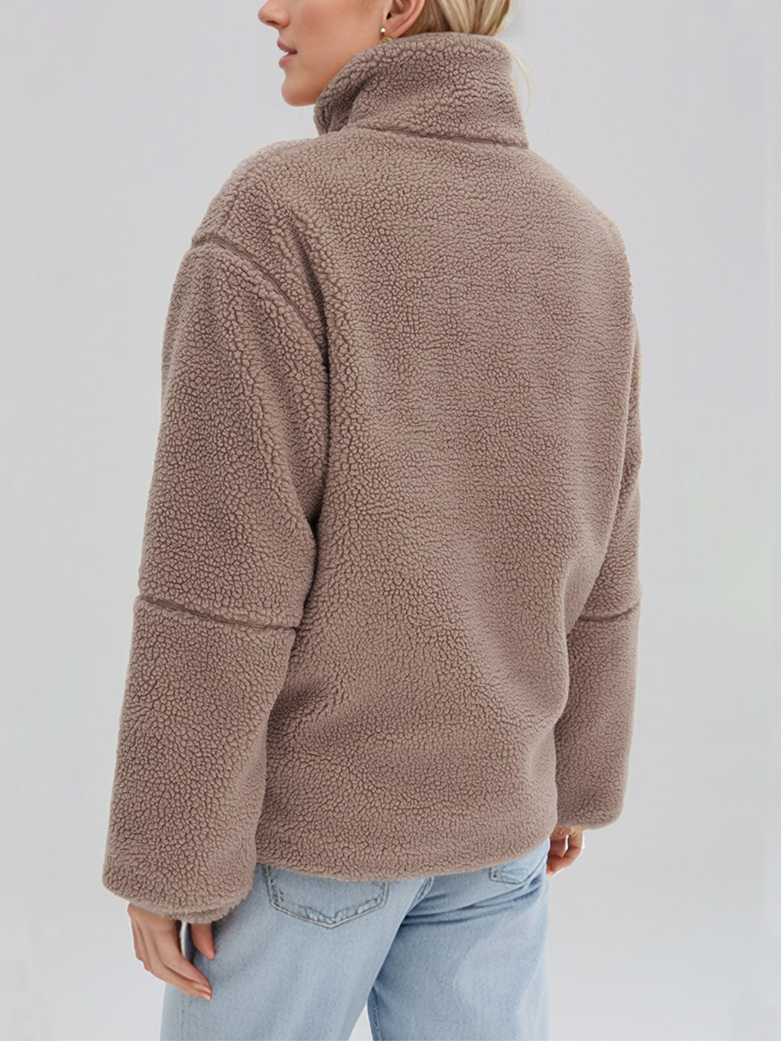 Tan sherpa stand-collar jacket with a textured fleece material and relaxed fit.