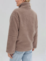 Tan sherpa stand-collar jacket with a textured fleece material and relaxed fit.