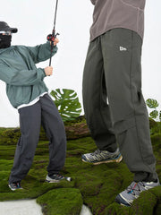 Dark gray utility joggers with relaxed fit and cargo pockets.