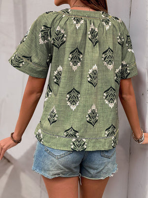 Botanical print V-neck blouse in matcha green with short sleeves and a relaxed fit.