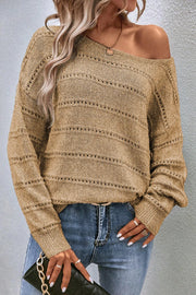 Off-the-shoulder tan knit pullover sweater with openwork details and boat neckline.