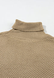 Khaki textured knit turtleneck sweater with cap sleeves and a waffle knit pattern.