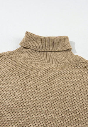Khaki textured knit turtleneck sweater with cap sleeves and a waffle knit pattern.