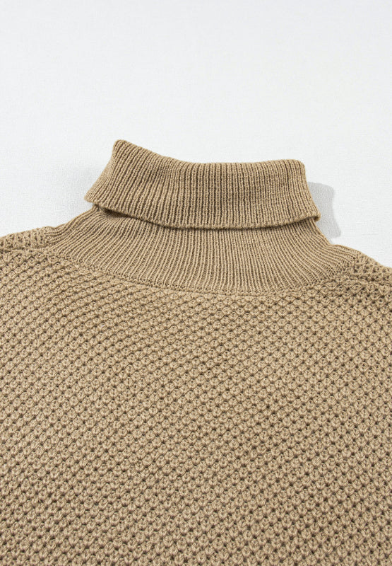 Khaki textured knit turtleneck sweater with cap sleeves and a waffle knit pattern.