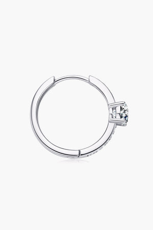 Silver pavé halo moissanite hoop earring with a central stone.