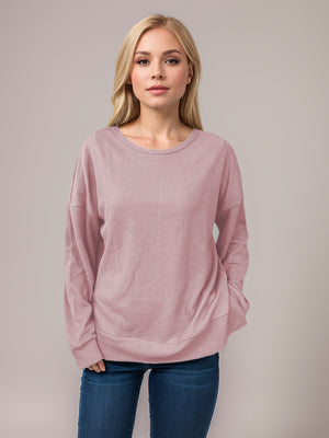 Dusty Pink waffle knit crewneck top with relaxed fit and long sleeves.