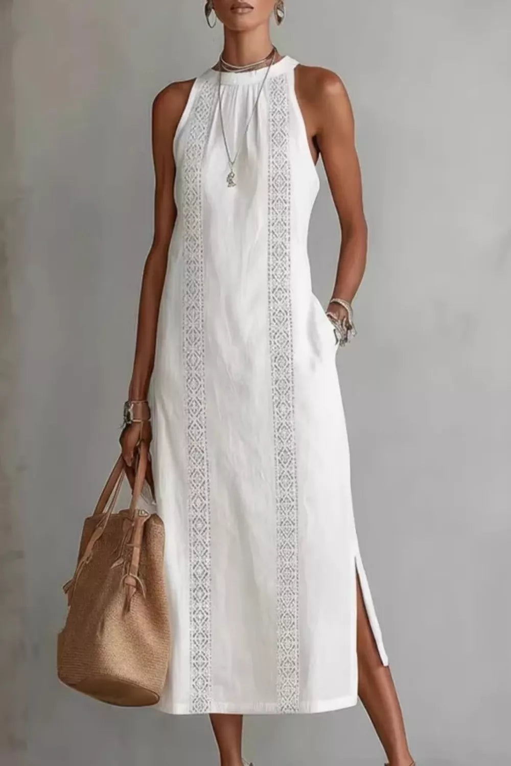 White midi dress with lace trim and pockets, sleeveless, high neck, side slits.