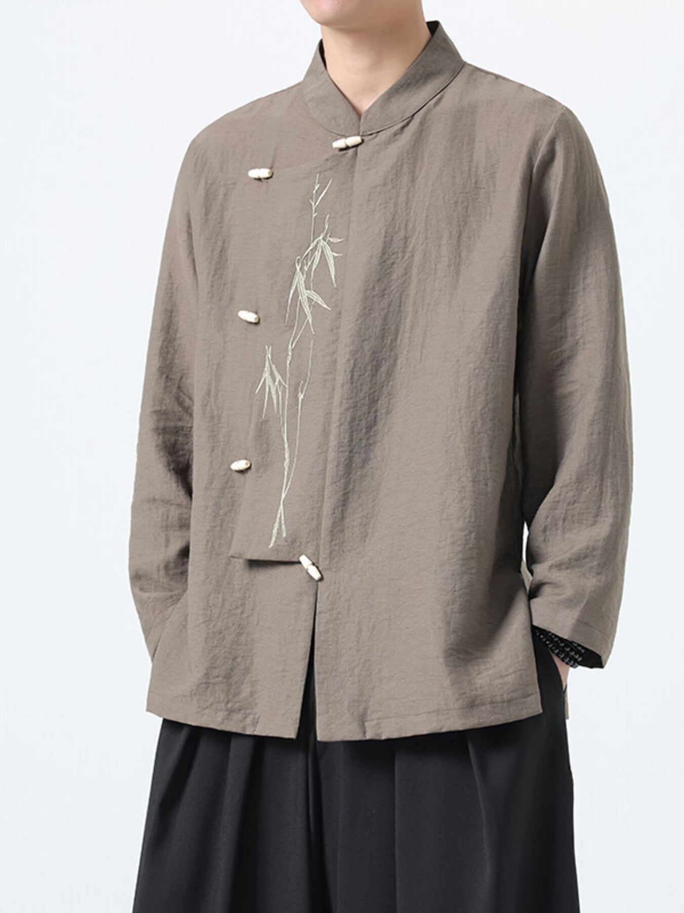 Men's mocha cotton shirt with mandarin collar, bamboo embroidery, and button closure.