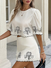 White floral embroidered two-piece set with puff sleeves and scalloped trim.