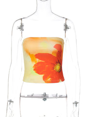 Floral print strapless tube top with orange flower on yellow and orange gradient background.