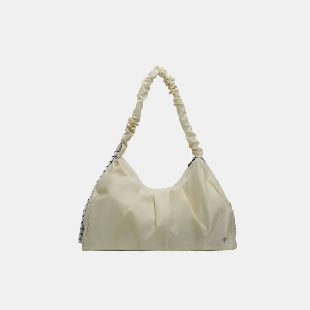 Ivory ruched handle crescent shoulder bag with ruched strap and subtle pleating.