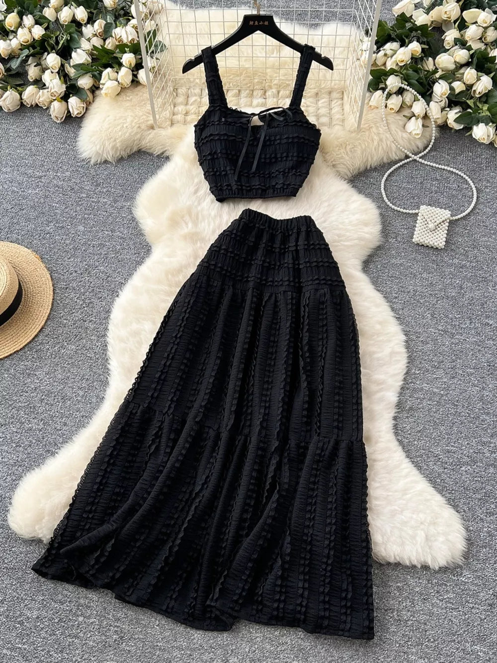 Black ruched crop top and maxi skirt set with tie detail and tiered skirt.